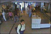 Hijacker Khalid al Mihdhar, foreground, passes through security at Dulles International Airport hours before American Airlines Flight 77 slammed into the Pentagon