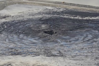 The Mosaic plant sinkhole in what was a large pond atop a gypsum stack. When the sinkhole opened, millions of gallons of acidic wastewater drained into an aquifer used for drinking water. Photo: WFLA Tampa