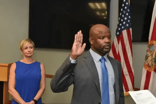 Broward Sheriff Gregory Tony being sworn in on Jan. 11, 2019 as his wife, Holly, looks on ﻿